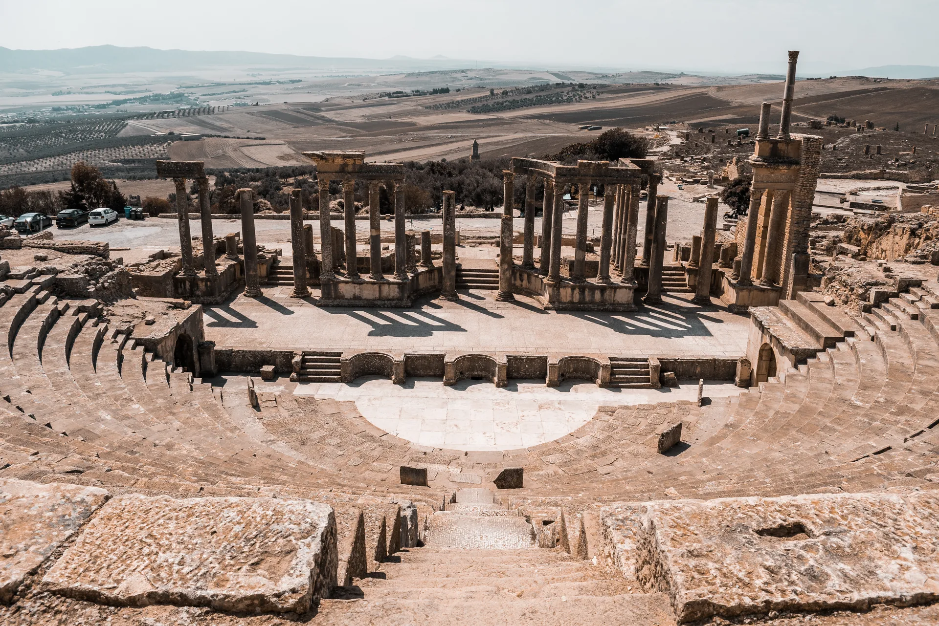 The Roman theatre at Dougga, Tunisia, with hilltop views beyond
